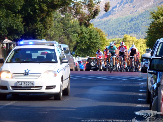 Police car escorting riders into Franshhoek during the Cape Rouleur